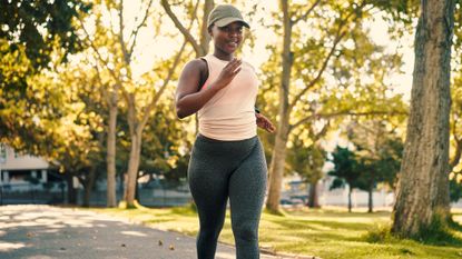 A woman power walking in the park