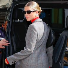 Sofia Richie leaving the Prada show in Milan wearing a suit and sunglasses