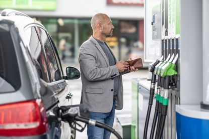 A man pays for gas at a gas pump.