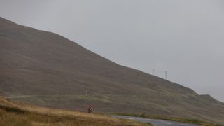Female rider alone on part of An Turas Mor, a bikepacking route in Scotland