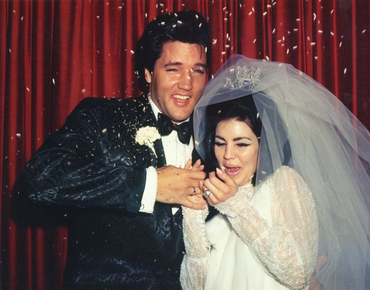 Elvis and Priscilla avoid the confetti. May 01,1967
