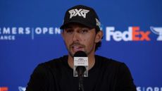 Marco Penge speaks to the media ahead of the Farmers Insurance Open wearing a black top and black PXG cap