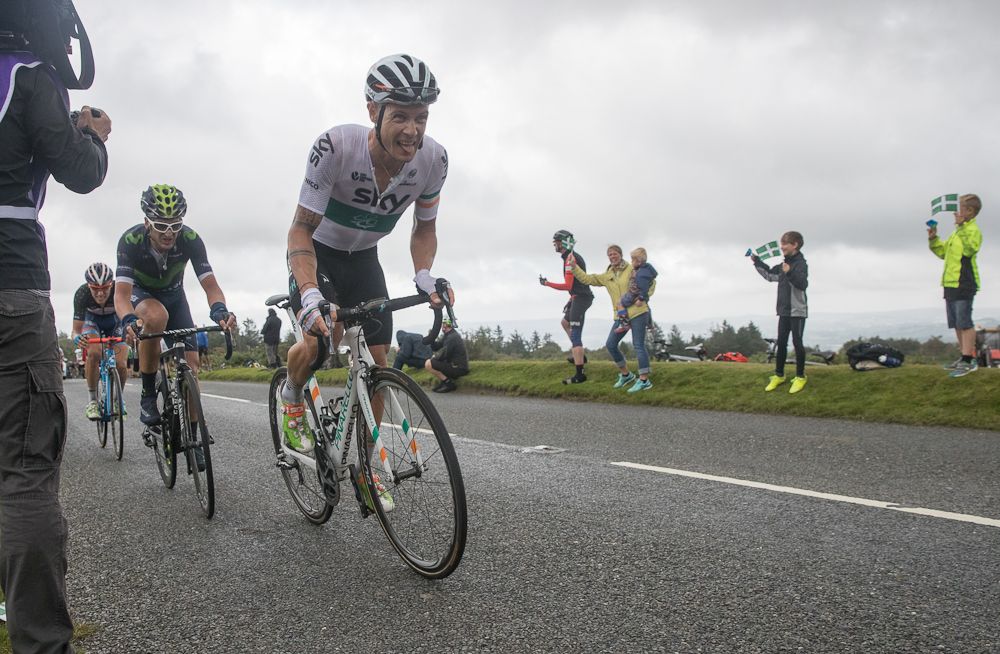 Cyclists competing in the Tour of Britain cycle towards the race finish of Stage Six at Haytor Rocks on Dartmoo at the Tour of Britain