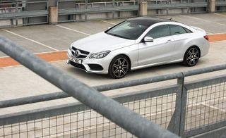 Alternative view of a silver car parked in an empty carpark