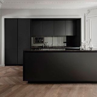kitchen with black cabinet and wooden flooring