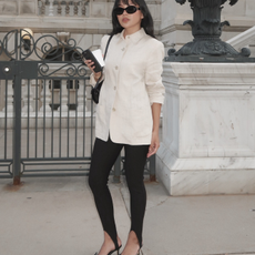 Fashion person Dawn Tan wears a winter legging trend. She wears a cream blazer, stirrup leggings and black bow kitten heels. This image was recently taken from her Instagram.