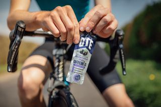 Image shows rider taking caffeine in coffee and gels on a bike ride.