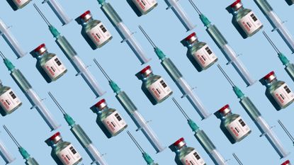 Covid-19 vaccines and vials on blue background