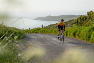 Issy rides away from the coast on a summer's day