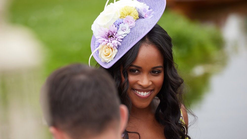 The Courtship Nicole Remy in a hat staring at suitor