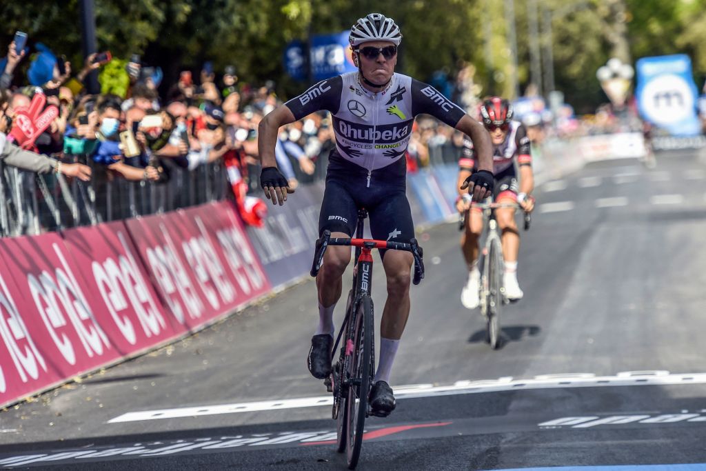 Team Qhubeka Assos rider Switzerlands Mauro Schmid celebrates as he crosses the finish line to win the eleventh stage of the Giro dItalia 2021 cycling race 162 km between Perugia and Montalcino on May 19 2021 Photo by Luca BETTINI AFP Photo by LUCA BETTINIAFP via Getty Images