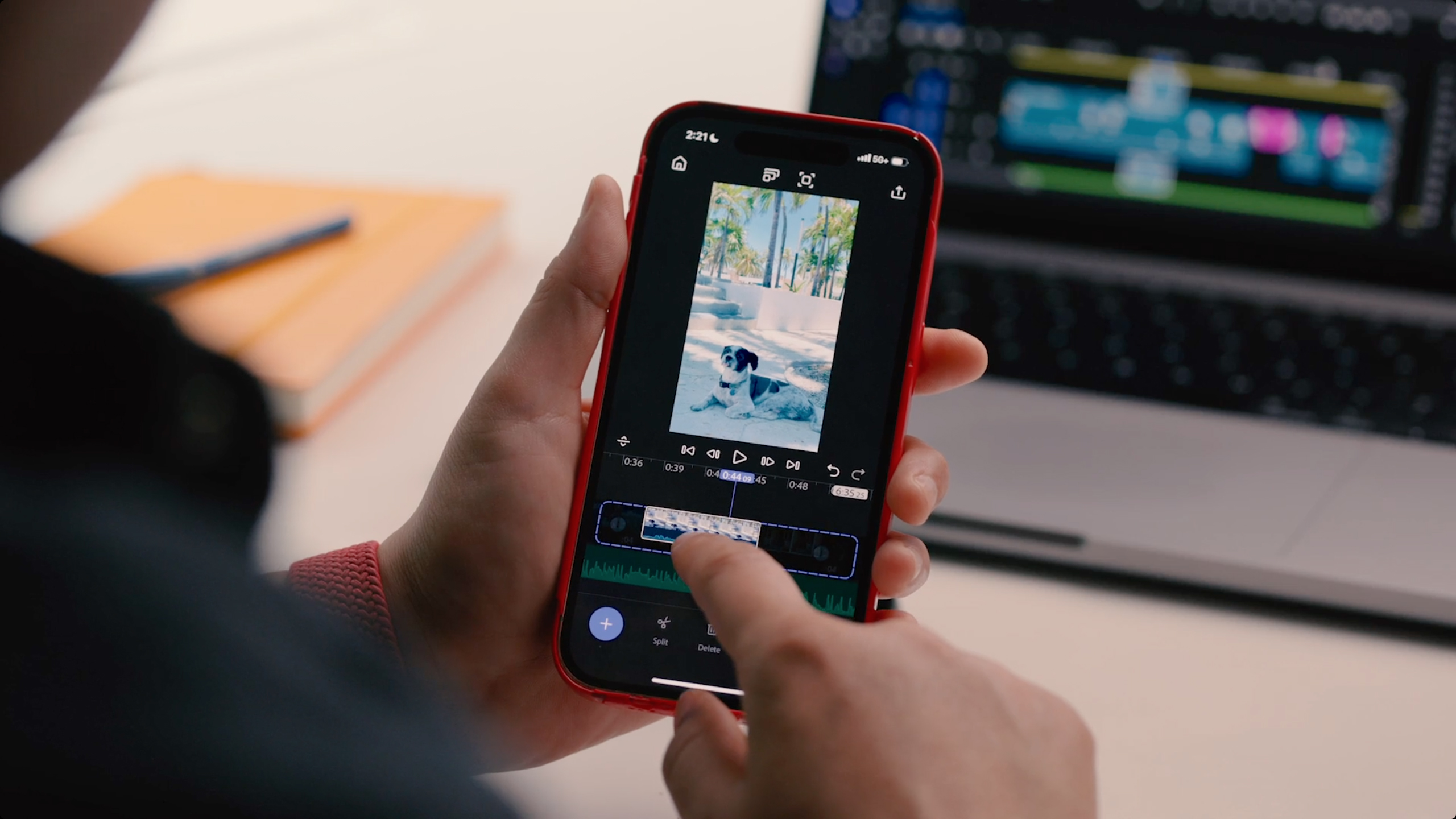 A person uses Adobe Premiere on an iPhone