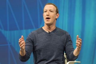 Zuckerberg on a chair at a conference