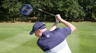 A golfer swings the Titleist TSR2 Fairway Wood on the golf course