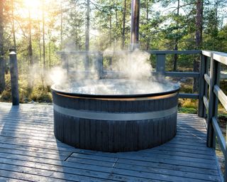 A barrel hot tub in a forest setting