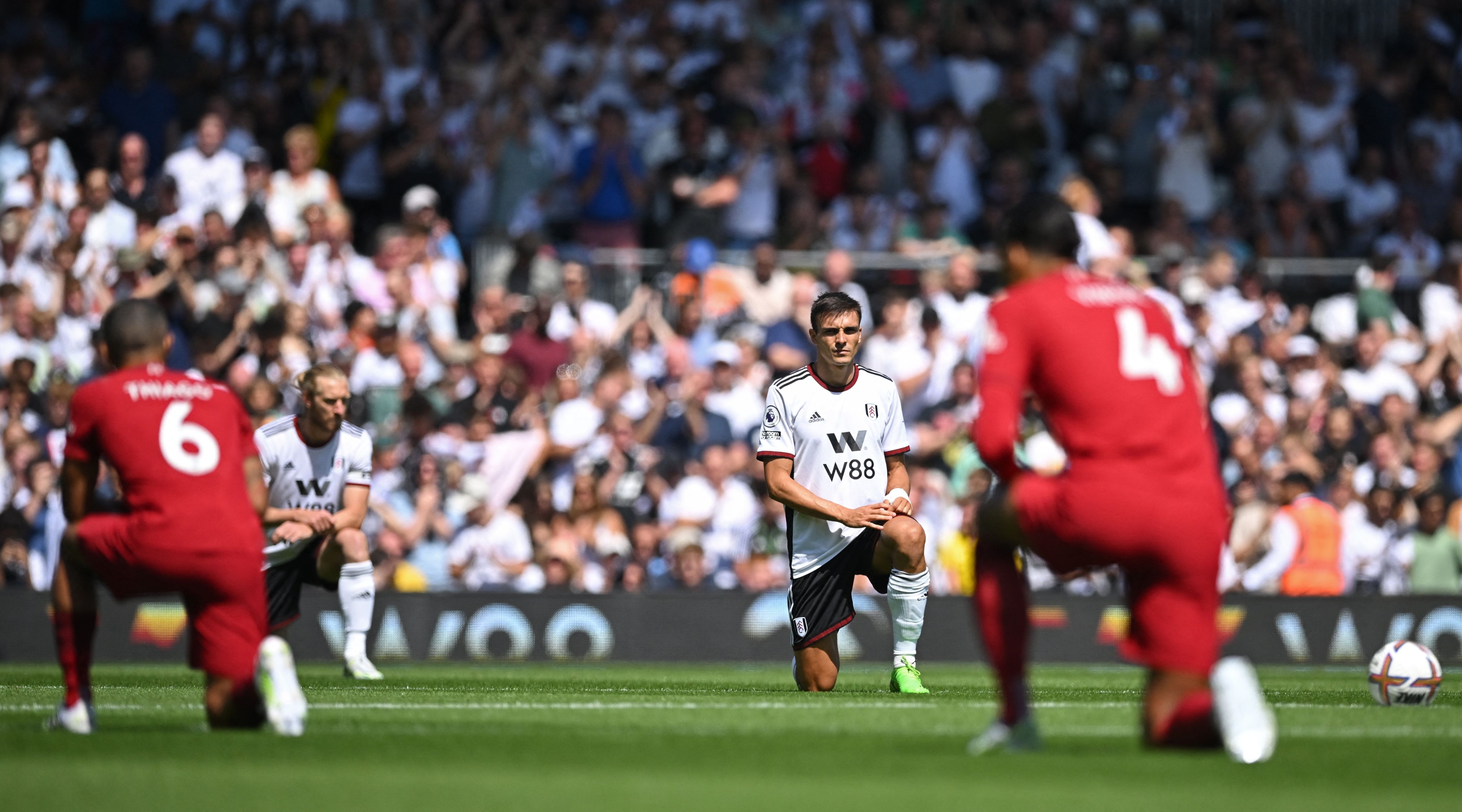Players take a knee in support of the Premier League's No Room For Racism campaign ahead of the English Premier League football match between Fulham and Liverpool at Craven Cottage in London on August 6, 2022