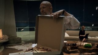 Obadiah Stane (Jeff Bridges) holds a pizza in Iron Man