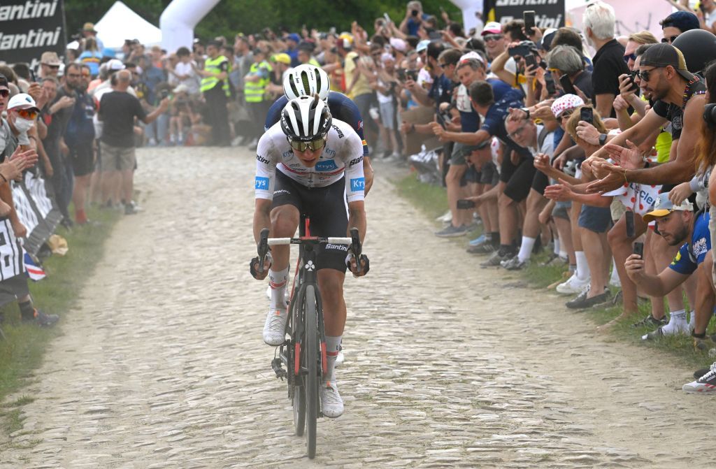 UAE Team Emirates teams Slovenian rider Tadej Pogacar wearing the best young riders white jersey cycles across a cobblestone sector in the final kilometers of the 5th stage of the 109th edition of the Tour de France cycling race 1537 km between Lille and Arenberg Porte du Hainaut in northern France on July 6 2022 Photo by Bernard PAPON POOL AFP Photo by BERNARD PAPONPOOLAFP via Getty Images