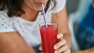 A woman drinking tart cherry juice