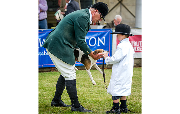 Master and huntsman of the Trinity Foot and South Herts Beagles Matthew Higgs with his son Jack who was holding hounds throughout the judging