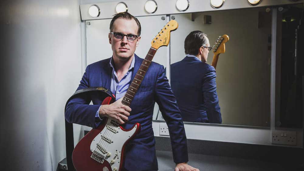 Joe Bonamassa standing against a dressing room mirror