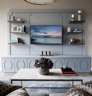 living room with blue bespoke shelving unit and tv wall