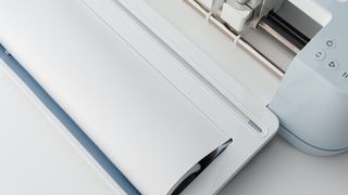 A photo of Smart Materials feeding into a Cricut machine