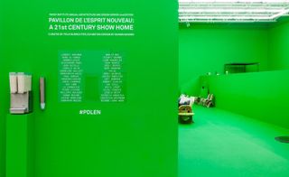 Entrance to a design 'show home'. All walls and floors are bright green. Before entering a list of architects' and designers' names is displayed on the wall.