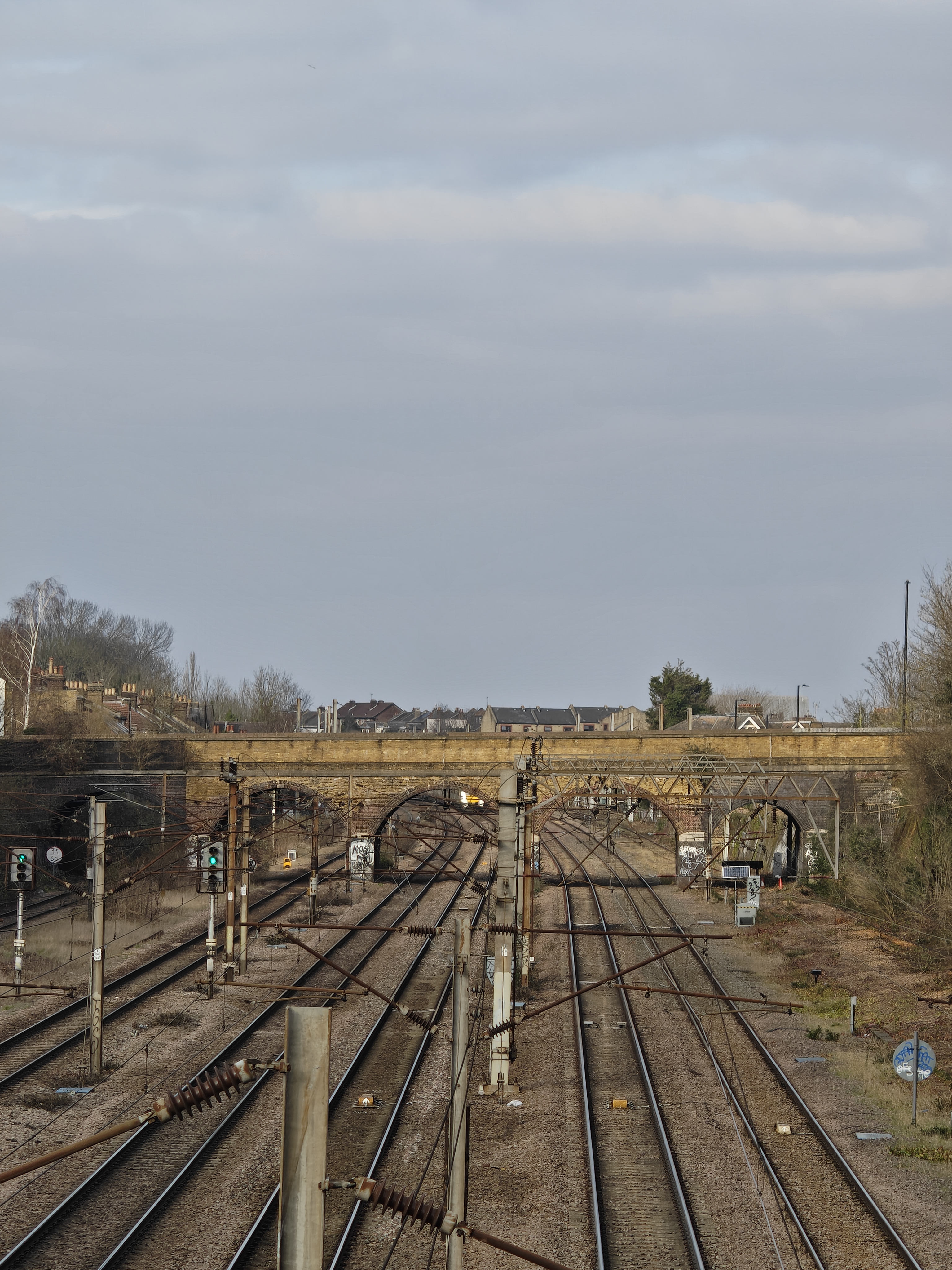 A railway track leading up to a stone bridge