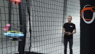 A drone pilot steers a drone in a match of drone soccer.