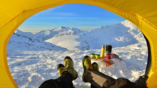 winter camping: looking out from a tent in winter