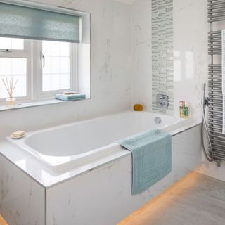 bathroom with white walled tiles and bathtub