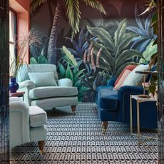 Living room with palm mural and blue sofas