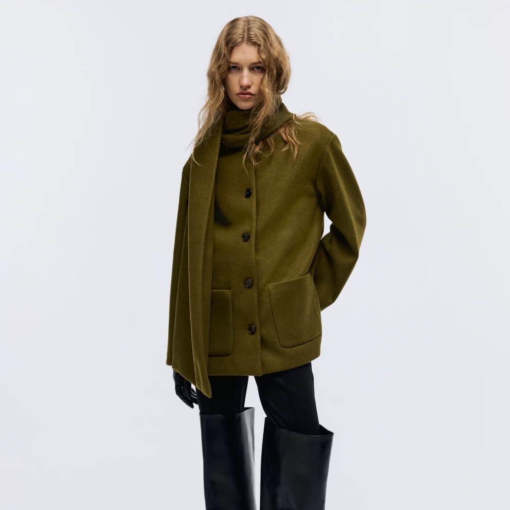 Model wearing a H&M olive green scarf coat from the H&M Black Friday sale
