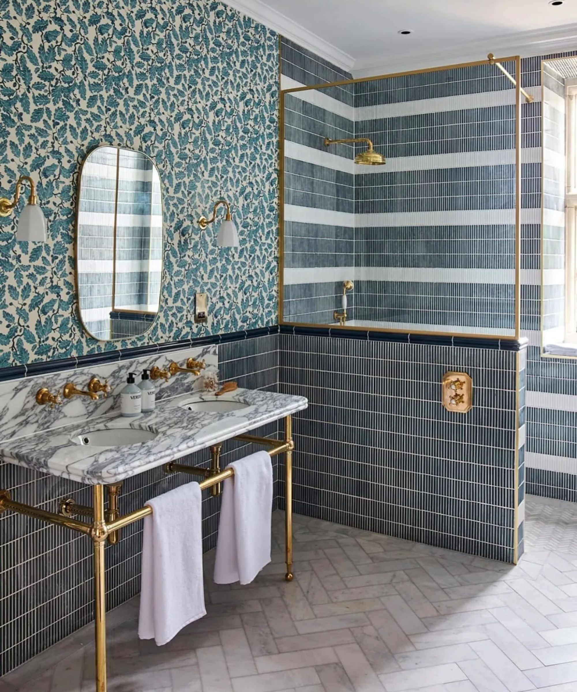 traditional bathroom with wallpaper and a striped tile shower