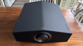 Sony Bravia Projector 9 home cinema projector on wooden dining table slight top down view