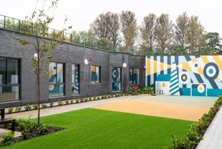 the entrance courtyard with greenery and mural at colourful space for young mental health patients in Edinburgh