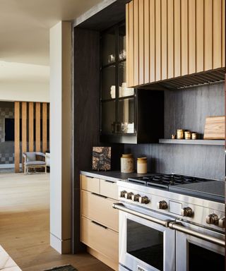 Dark grey kitchen with mid tone wood doors