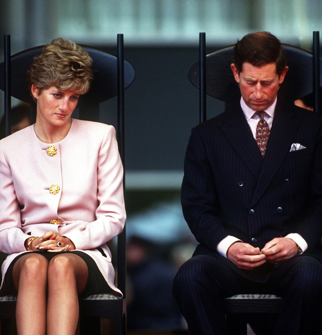 Princess Diana and Prince Charles looking away from each other with serious expressions