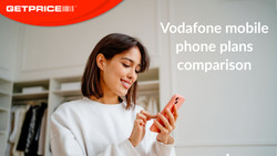Woman smiling and looking at her phone and typing with red GetPrice logo on top left and Vodafone mobile plans comparison written in white on the right side