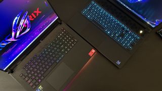Alienware M18 vs Asus ROG Strix Scar 18 keyboards on a black table