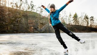 A woman ice skates on a frozen lake