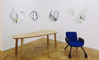 Table, chair, and wall-mounted mirrors