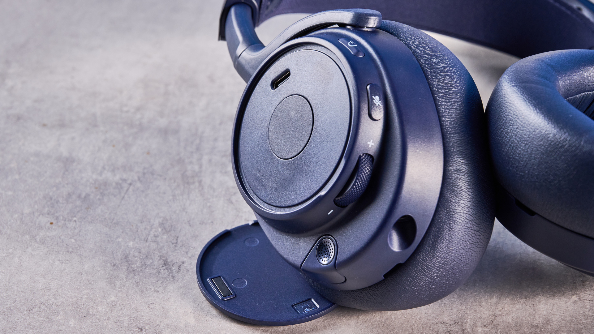 The SteelSeries Arctis Nova Pro Omni on a stone surface against a blue background