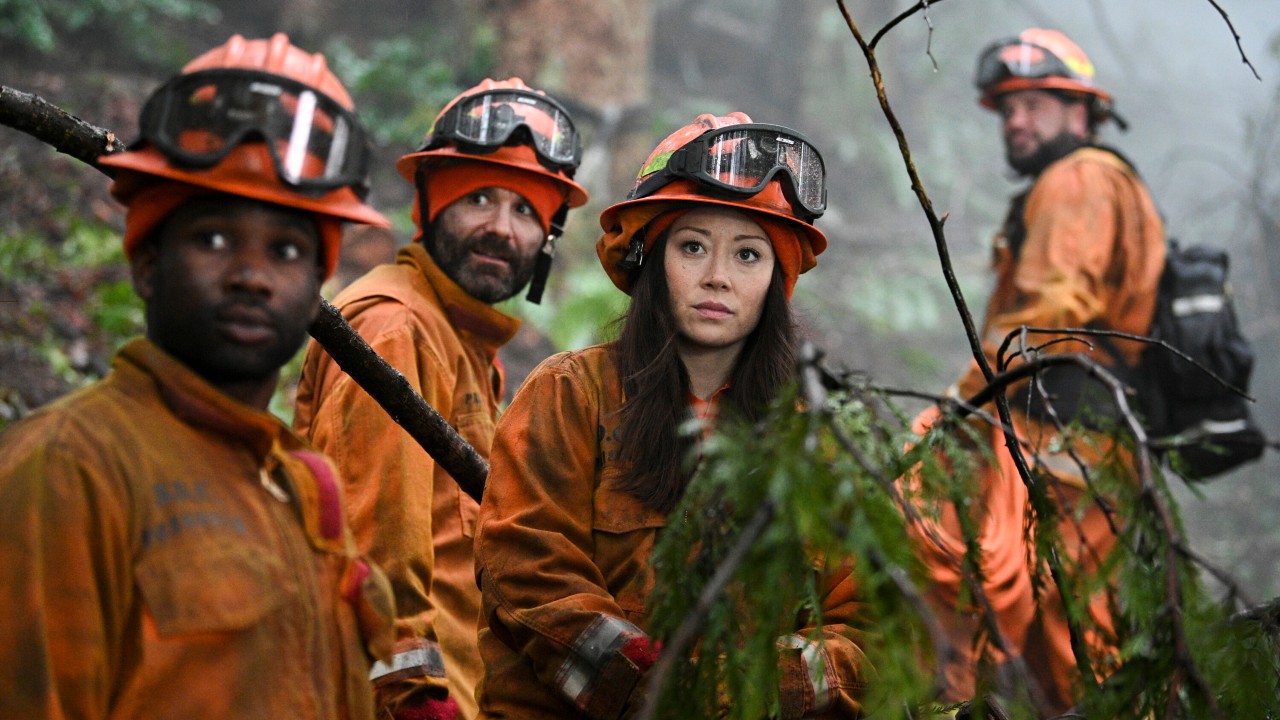 Fiona Rene as Rebecca Lee.  stand among other firefighters on Fire Country