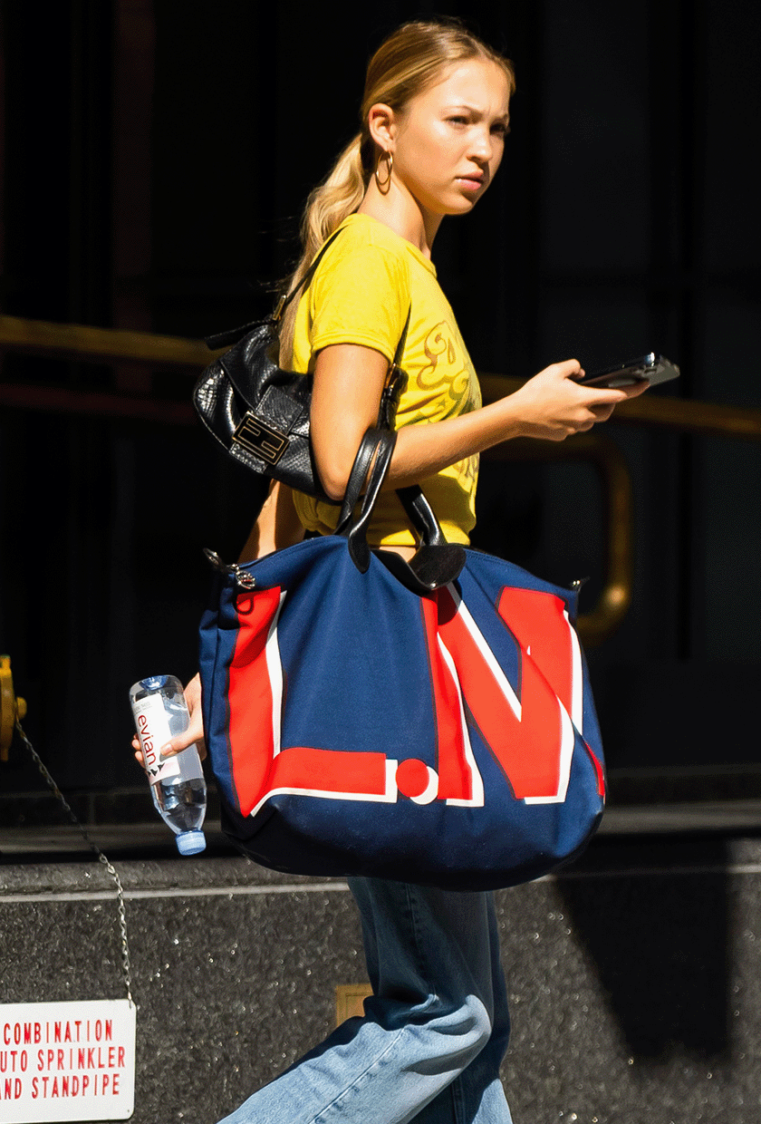 Lila Moss carrying a Longchamp Le Pliage bag.