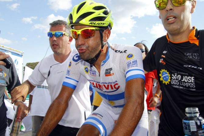 Stage winner Daniel Diaz is escorted to the podium