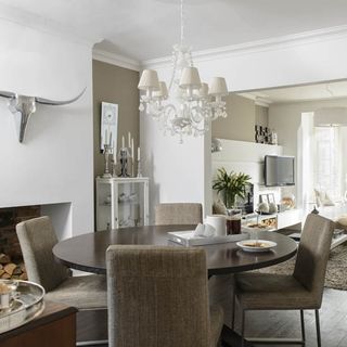 dining area with white wall and round table and chairs