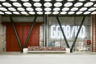 Bench with large doors and industrial pillars behind it