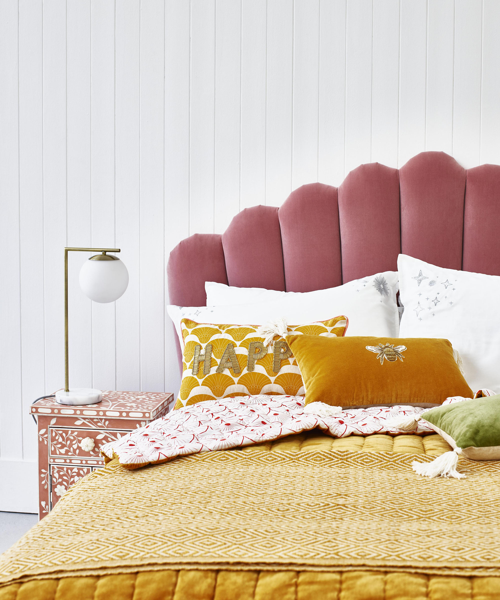 Pink scalloped velvet headboard by Oliver Bonas